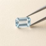 Aquamarine · No. 130 held in tweezers on ivory paper