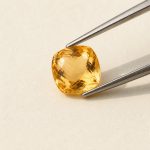 Citrine · No. 87 held in tweezers on ivory paper